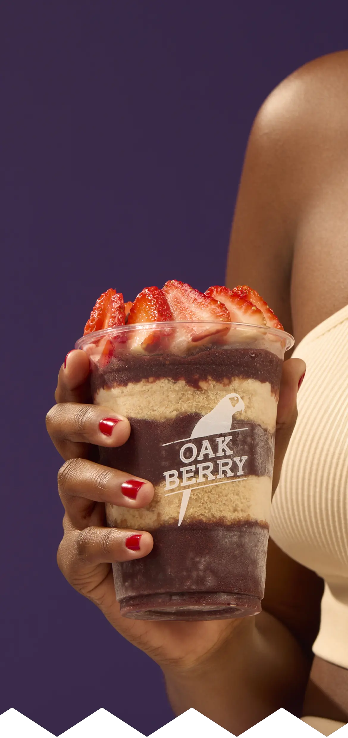 A hand holding an OAKBERRY bowl