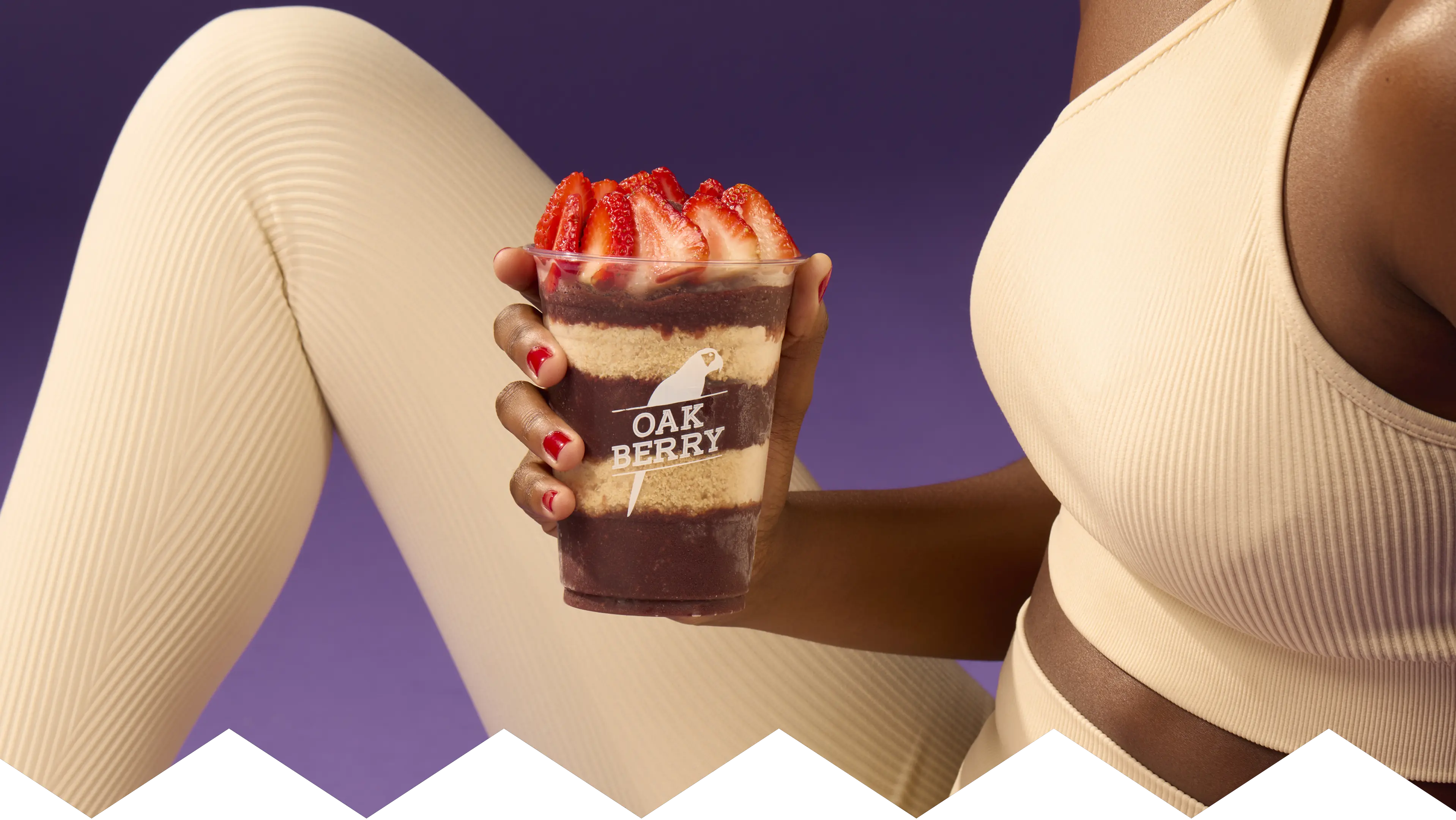 A hand holding an OAKBERRY bowl