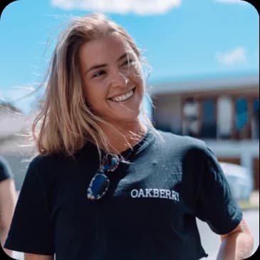 A person smiling with OAKBERRY uniform