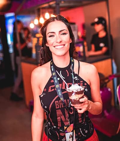 A person smiling at camera holding an OAKBERRY Bowl