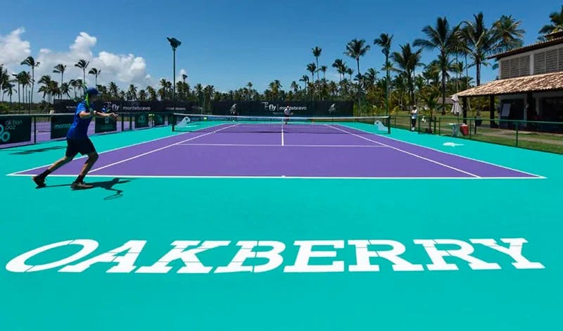 A tennis court with a net and a tennis ball